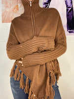 loose fit poncho with high neck and hanging frings