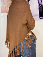 loose fit poncho with high neck and hanging frings